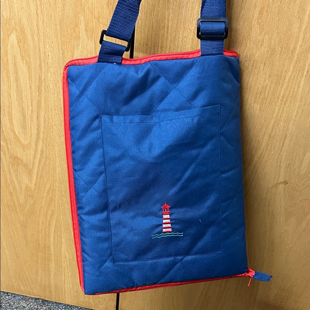 Blue Quilted Bag folds out to blanket/mat with  Embroidered Lighthouse on pocket